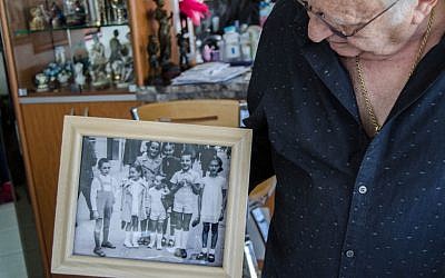 Ivan Gabor grew up in Baimare, Hungary until his family packed its things and left for Budapest in the wake of hostilities to Jews. In the picture Ivan holds,only he and the girl at the top left were not murdered in the Holocaust. (photo credit: Gideon Grubo)