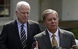 Senator Lindsey Graham, right, accompanied by Senator John McCain, speaks with reporters outside the White House in Washington, DC, in September 2013. (AP/Pablo Martinez Monsivais)