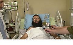 Rabbi Ovadia Isakov recovering in an Israeli hospital after being shot outside his home in Derbent. (photo credit: YouTube/Shneor Schiff )