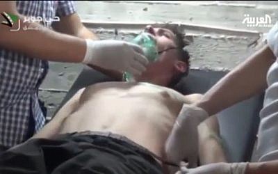 A young man receives medical treatment after what Syrian rebels claim was a chemical weapons attack in the Jobar neighborhood of Damascus on September 12, 2013 screen capture: YouTube)