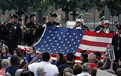 The World Trade Center Flag is presented as friends and relatives of the victims of the 9/11 terrorist attacks gather at the National September 11 Memorial at the World Trade Center site, Sept. 11, 2013. (AP/Jason DeCrow)