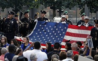 The World Trade Center Flag is presented as friends and relatives of the victims of the 9/11 terrorist attacks gather at the National September 11 Memorial at the World Trade Center site, Sept. 11, 2013. (AP/Jason DeCrow)