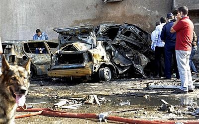 Security officials examine the site of a car bomb in the Suez Canal city of Ismailia, Egypt, Saturday Oct. 19, 2013. A car bomb exploded Saturday near an Egyptian military intelligence compound in the Suez Canal city of Ismailia, wounding several soldiers, security officials said, as militants appear to be expanding the scope of attacks beyond the restive Sinai Peninsula. (AP Photo)
