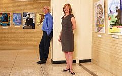 David (left) and Leanne Matlow pose next to posters exhibited at Toronto's Beth Tzedec Congregation from Matlow's personal Herzl collection of over 2,500 items. (photo credit: Laura Arsie)
