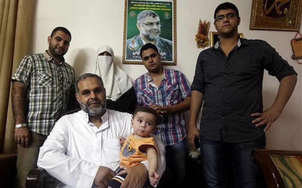 In this Tuesday, June 25, 2013, members of Rantisi family pose for a photo at their house in Gaza City. From right, counter-clockwise, are Anaz, 22, Malik, 18, Kifah, Baraa's mother, 47, Baraa, 23, Mohammed his father, 55, and Baraa's 10-month-old son Mohammed. (photo: AP/Hatem Moussa) In this Tuesday, June 25, 2013, members of Rantisi family pose for a photo at their house in Gaza City. From right, counter-clockwise, are Anaz, 22, Malik, 18, Kifah, Baraa's mother, 47, Baraa, 23, Mohammed his father, 55, and Baraa's 10-month-old son Mohammed. (photo: AP/Hatem Moussa)