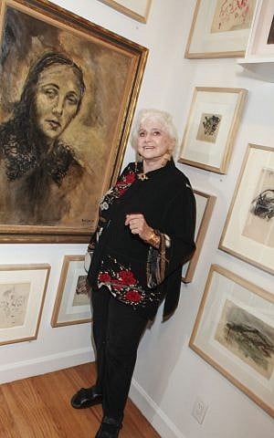 Curator Gertrude Stein stands beside Boris Lurie's portrait of his mother. (photo credit: courtesy)