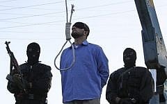File: A blindfolded man waits to be hanged in public as two police officers look on in Shiraz, Iran, April 16, 2011. (AP/Mehr News Agency/Mohammad Hadi Khosravi)