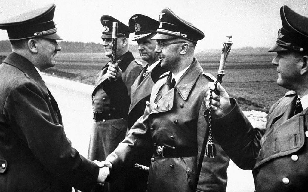 Adolf Hitler (left) shakes hands with Heinrich Himmler somewhere in Germany on May 18, 1944. From left to right: Hitler, Minister Field Marshal Wilhelm Keitel, Admiral Karl Doenitz, Himmler and Field Marshal General Erhard Milch. (AP) Adolf Hitler (left) shakes hands with Heinrich Himmler somewhere in Germany on May 18, 1944. From left to right: Hitler, Minister Field Marshal Wilhelm Keitel, Admiral Karl Doenitz, Himmler and Field Marshal General Erhard Milch. (AP)
