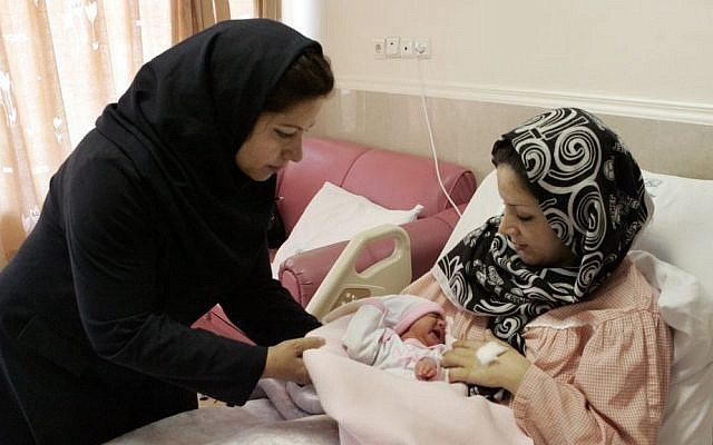 Iranian nurse Zahra Akbarzadeh, left, gives one-day-old baby girl Setayesh to her mother, Tayyebeh Sadat Bidaki, to feed her at the Mehr hospital, in Tehran, Sunday, July 29, 2012 (photo credit: AP/Vahid Salemi) Iranian nurse Zahra Akbarzadeh, left, gives one-day-old baby girl Setayesh to her mother, Tayyebeh Sadat Bidaki, to feed her at the Mehr hospital, in Tehran, Sunday, July 29, 2012 (photo credit: AP/Vahid Salemi)