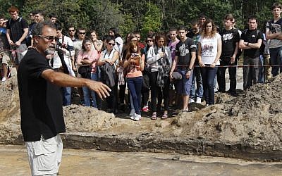 Israeli archaeologist Yoram Haimi talks to a group of young people from the Dror School in Israel about his findings at the site of the former German Nazi death camp Sobibor, in eastern Poland. (photo credit: AP Photo/Czarek Sokolowski, File) Israeli archaeologist Yoram Haimi talks to a group of young people from the Dror School in Israel about his findings at the site of the former German Nazi death camp Sobibor, in eastern Poland. (photo credit: AP Photo/Czarek Sokolowski, File)