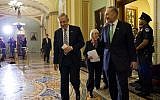 Senate Majority Leader Sen. Harry Reid, left, walks off the Senate floor with Sen. Chuck Schumer after voting to avoid a financial default and reopen the government after a 16-day partial shutdown, in October 2013 (photo credit: AP/Evan Vucci)