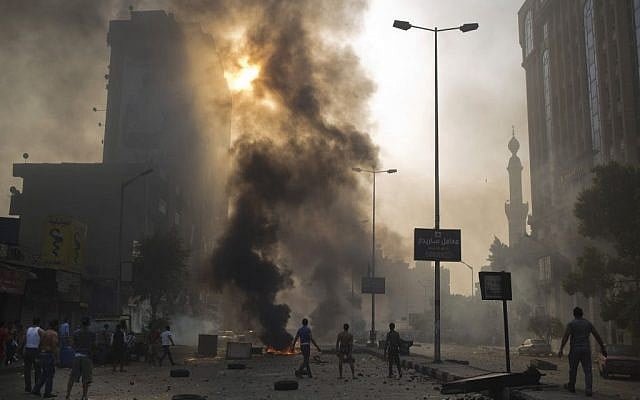 Supporters and opponents of Egypt's ousted Islamist President Mohammed Morsi clash in Cairo, Egypt, Sunday, Oct. 6, 2013. (photo credit: AP/Hassan Ammar) Supporters and opponents of Egypt's ousted Islamist President Mohammed Morsi clash in Cairo, Egypt, Sunday, Oct. 6, 2013. (photo credit: AP/Hassan Ammar)