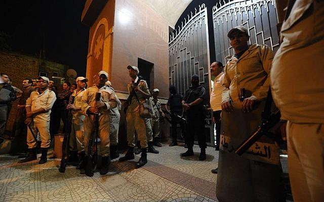 Illustrative photo of Egyptian security forces standing guard at a Coptic Christian church, October 20, 2013 (photo credit: AP/Amr Mohsen)