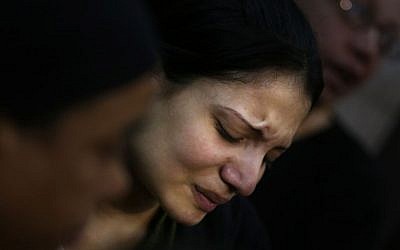 An Egyptian woman mourns during the funeral of several Coptic Christians who were killed late Sunday, in Warraq's Virgin Mary church in Cairo, Egypt, on Monday (photo credit: AP/Khalil Hamra)
