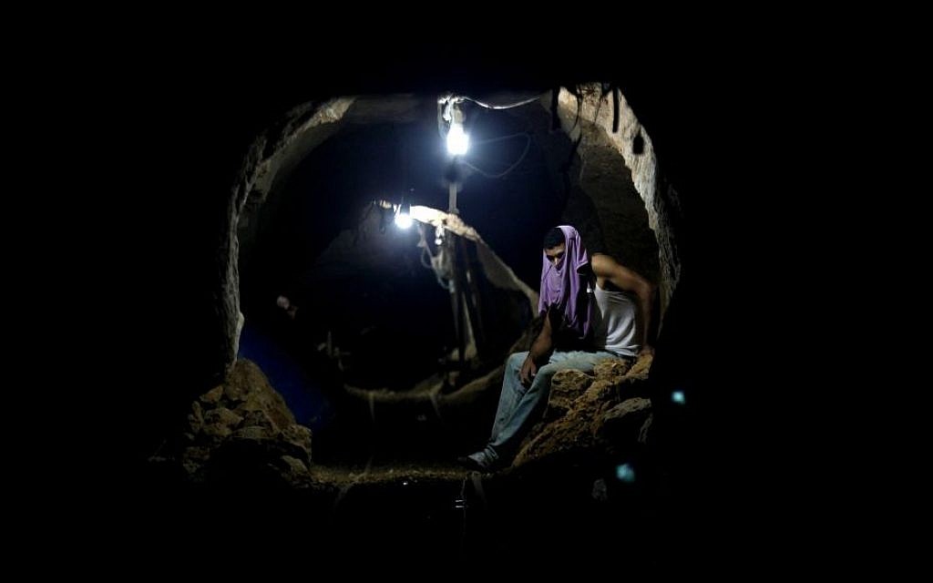 A Palestinian sits in one of Gaza's smuggling tunnels (photo credit: Hatem Moussa/AP) A Palestinian sits in one of Gaza's smuggling tunnels (photo credit: Hatem Moussa/AP)