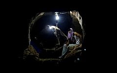 A Palestinian sits in one of Gaza's smuggling tunnels (photo credit: Hatem Moussa/AP)
