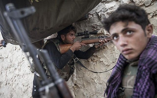 Opposition fighters mount guard at the frontline on the outskirts of Kfar Lata. (photo credit: AP Photo) Opposition fighters mount guard at the frontline on the outskirts of Kfar Lata. (photo credit: AP Photo)