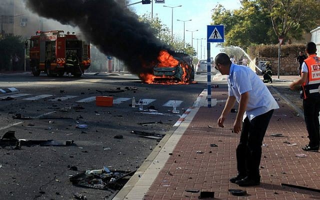 Israeli rescue forces extinguish the fire after a car exploded in Ashkelon on October 24, 2013. Two men were seriously injured in the blast, and one later died of his wounds while hospitalized. The attack is beleived to be criminally motivated. (Photo credit: Edi Israel/Flash90) Israeli rescue forces extinguish the fire after a car exploded in Ashkelon on October 24, 2013. Two men were seriously injured in the blast, and one later died of his wounds while hospitalized. The attack is beleived to be criminally motivated. (Photo credit: Edi Israel/Flash90)
