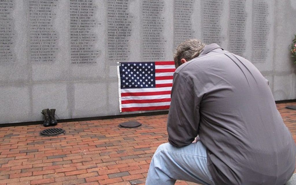 Former Marine Ed Ayers of Scranton, Penn., hangs his head and weeps at the Beirut Bombing Memorial in Jacksonville, NC, on Wednesday (photo credit: AP/Allen G. Breed) Former Marine Ed Ayers of Scranton, Penn., hangs his head and weeps at the Beirut Bombing Memorial in Jacksonville, NC, on Wednesday (photo credit: AP/Allen G. Breed)