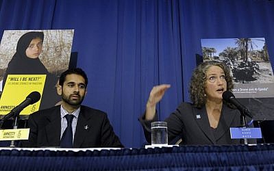 Letta Tayler, senior counterterrorism researcher at Human Rights Watch, right, accompanied by Mustafa Qadri, a Pakistan researcher at Amnesty International, talks about the findings of two new reports, by the two human rights groups, on US drone strikes and other air strikes in Pakistan and Yemen in Washington, DC on  Oct. 22, 2013 (photo credit: AP/Susan Walsh)