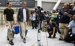 John Greyson, right, and Tarek Loubani arrive at the Pearson International Airport in Toronto, Friday Oct. 11, 2013. Two Canadians who spent seven weeks in an Egyptian prison without being charged have returned home to Canada. (AP Photo/The Canadian Press, Mark Blinch)