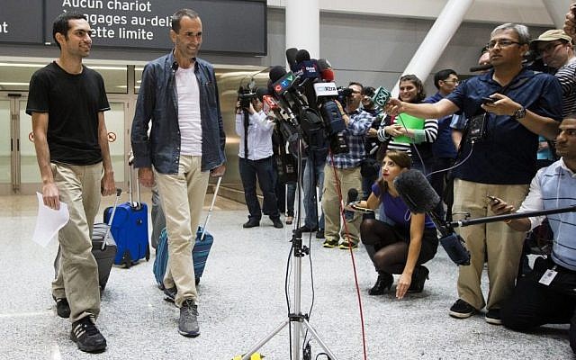 John Greyson, right, and Tarek Loubani arrive at the Pearson International Airport in Toronto, Friday Oct. 11, 2013. Two Canadians who spent seven weeks in an Egyptian prison without being charged have returned home to Canada. (AP Photo/The Canadian Press, Mark Blinch) John Greyson, right, and Tarek Loubani arrive at the Pearson International Airport in Toronto, Friday Oct. 11, 2013. Two Canadians who spent seven weeks in an Egyptian prison without being charged have returned home to Canada. (AP Photo/The Canadian Press, Mark Blinch)