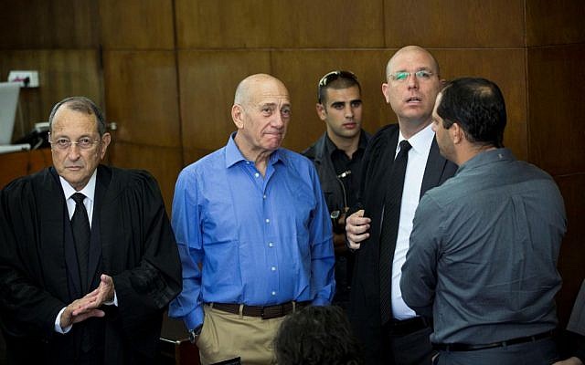 Former prime minister Ehud Olmert, seen with his lawyers in court as he prepares to give testimony at the Holyland trial, on October 1, 2013. (photo credit: Tal Shahar/Pool/Flash90)