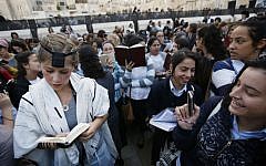 Young ultra-Orthodox women ridicule a prayer shawl-clad female worshiper at the Western Wall during a monthly prayer session of the Women of the Wall group, Friday, October 4, 2013 (photo credit: Miriam Alster/Flash90)