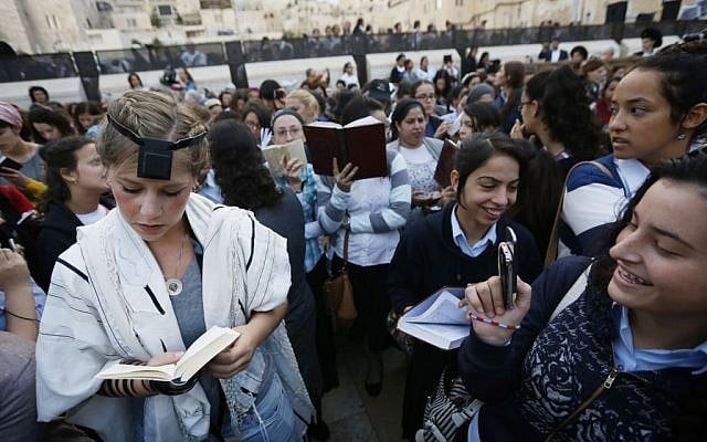 Young ultra-Orthodox women ridicule a prayer shawl-clad female worshiper at the Western Wall during a monthly prayer session of the Women of the Wall group, Friday, October 4, 2013 (photo credit: Miriam Alster/Flash90) Young ultra-Orthodox women ridicule a prayer shawl-clad female worshiper at the Western Wall during a monthly prayer session of the Women of the Wall group, Friday, October 4, 2013 (photo credit: Miriam Alster/Flash90)