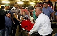 Noam Glick being brought to Shaare Zedek Medical Center in Jerusalem on October 5. (photo credit: Flash90)