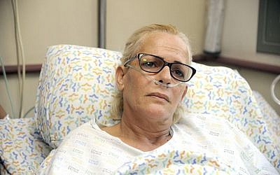 Monique Omer, whose husband Seraia Ofer was allegedly bludgeoned to death Thursday night by two Palestinians, speaks to the media at HaEmek Hospital in Afula on October 12, 2013 (Photo credit: Gil Eliyahu/JINIPIX/POOL/Flash90)