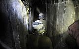 An Israeli soldier walks through a tunnel dug by Palestinians beneath the border between the Gaza Strip and Israel, uncovered by Israeli troops, on October 13, 2013. (\David Buimovitch/Flash90)