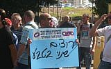 "We want a change at Teva" says the sign of a protester outside Teva Pharmaceutical's HQ on October 23. A change is what he got as CEO Jeremy Levin resigned on October 30 (photo credit: Roni Schutzer/Flash90)