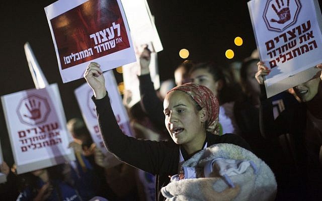 Protesters hold banners and pictures of Israelis killed by Palestinian terrorists, during a demonstration against the release of Palestinian prisoners from Israeli jails, outside the Ofer military prison near the West Bank city of Ramallah, Monday, Oct. 28, 2013. (Photo credit: Yonatan Sindel/Flash90) Protesters hold banners and pictures of Israelis killed by Palestinian terrorists, during a demonstration against the release of Palestinian prisoners from Israeli jails, outside the Ofer military prison near the West Bank city of Ramallah, Monday, Oct. 28, 2013. (Photo credit: Yonatan Sindel/Flash90)
