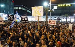Beit Shemesh residents holding signs as they protest in front of the municipality building in the city on October 29, 2013. (photo credit: Yonatan Sindel/Flash90)