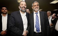 Shas party leader MK Aryeh Deri (left) seen shaking hands with fellow Shas MK Eli Yishai, after a meeting in the Knesset aimed to heal their feud, October 30, 2013. (Photo credit: Miriam Alster/FLASH90)