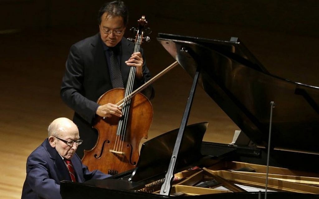 Holocaust survivor George Horner, front left, performs with cellist Yo-Yo Ma, top, on stage at Symphony Hall Tuesday, Oct. 22, 2013, in Boston. (photo credit: AP Photo/Steven Senne) Holocaust survivor George Horner, front left, performs with cellist Yo-Yo Ma, top, on stage at Symphony Hall Tuesday, Oct. 22, 2013, in Boston. (photo credit: AP Photo/Steven Senne)