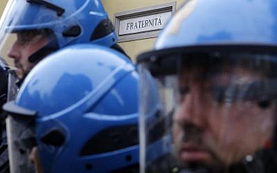 Police in riot gear guard the entrance of the Society of St. Pius X, a schismatic Catholic group, where the hearse carrying the coffin of Nazi war criminal Erich Priebke entered for his funeral service, in Albano Laziale, on the outskirts of Rome, Tuesday, Oct. 15, 2013. (photo credit: AP Photo/Riccardo De Luca)
