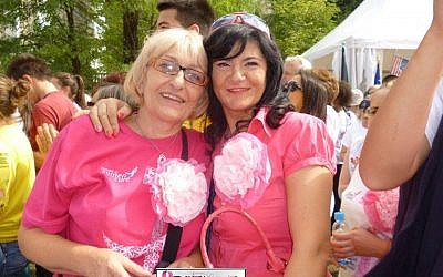 Maja Memic (left), and friend, in their pink breast cancer survivor shirts, celebrate at the Race for the Cure. (photo credit: Courtesy of JDC)