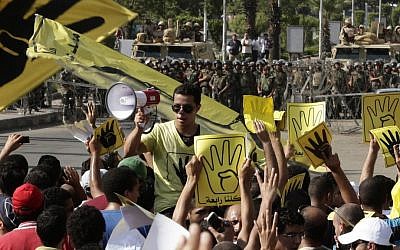 Supporters of Egypt's ousted president Mohammed Morsi chant slogans in Cairo, Egypt, during a demonstration earlier this month (photo credit: AP/Hassan Ammar)