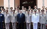Egypt's interim President Adly Mansour, center, Defense Minister Abdel-Fatah el-Sissi, front row, third left, and other officials pose for a photograph during a visit to the Secretariat of the Armed Forces, part of celebrations marking the 40th anniversary of the start of the 1973 (Yom Kippur) war in which Egyptian forces made initial gains against Israel, Saturday, Oct. 5, 2013 (photo credit: AP)