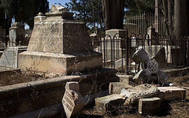 A damaged grave in the Protestant Cemetery of Mt. Zion, Jerusalem, on Monday (photo credit: AP/Bernat Armangue) A damaged grave in the Protestant Cemetery of Mt. Zion, Jerusalem, on Monday (photo credit: AP/Bernat Armangue)