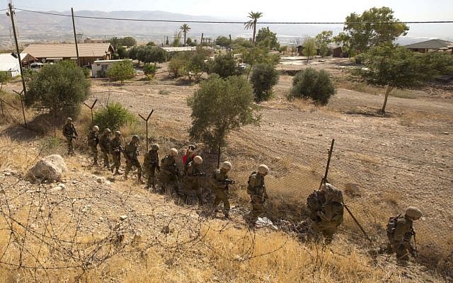 Troops combing the area next to the Brosh Habika vacation village Friday. (photo credit: AP/Sebastian Scheiner) Troops combing the area next to the Brosh Habika vacation village Friday. (photo credit: AP/Sebastian Scheiner)
