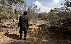 A member of Hamas inspects the damage following an Israeli air strike in Gaza City on Monday, Oct. 28, 2013. (photo credit: AP/Hatem Moussa)