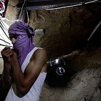 A Palestinian in a smuggling tunnel (photo credit: Hatem Moussa/AP) A Palestinian in a smuggling tunnel (photo credit: Hatem Moussa/AP)