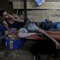 Smoking in a smuggling tunnel connecting Gaza and Egypt (photo credit: Hatem Moussa/AP) Smoking in a smuggling tunnel connecting Gaza and Egypt (photo credit: Hatem Moussa/AP)