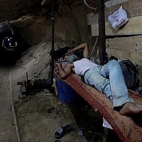 A Palestinian rests in a smuggling tunnel connecting Gaza and Egypt (photo credit: Hatem Moussa/AP) A Palestinian rests in a smuggling tunnel connecting Gaza and Egypt (photo credit: Hatem Moussa/AP)