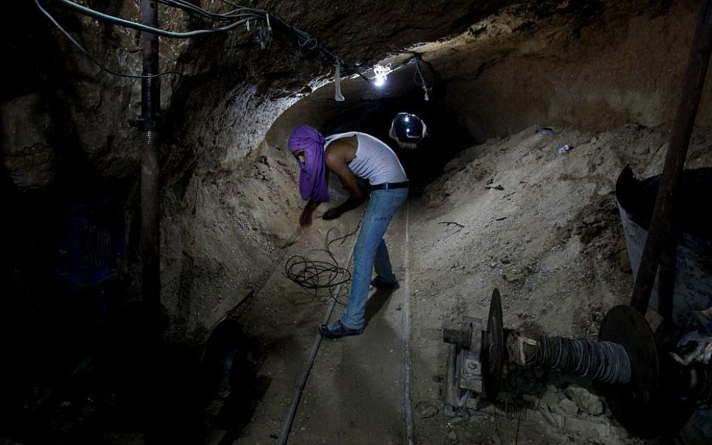 Working in a Palestinian smuggling tunnel connecting Gaza and Egypt in 2013. (photo credit: Hatem Moussa/AP) Working in a Palestinian smuggling tunnel connecting Gaza and Egypt in 2013. (photo credit: Hatem Moussa/AP)