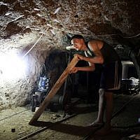 Illustrative: Working in a smuggling tunnel between Gaza and Egypt (photo credit: Hatem Moussa/AP) Illustrative: Working in a smuggling tunnel between Gaza and Egypt (photo credit: Hatem Moussa/AP)