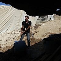 A Palestinian works outside one of Gaza's smuggling tunnels (photo credit: Hatem Moussa/AP) A Palestinian works outside one of Gaza's smuggling tunnels (photo credit: Hatem Moussa/AP)